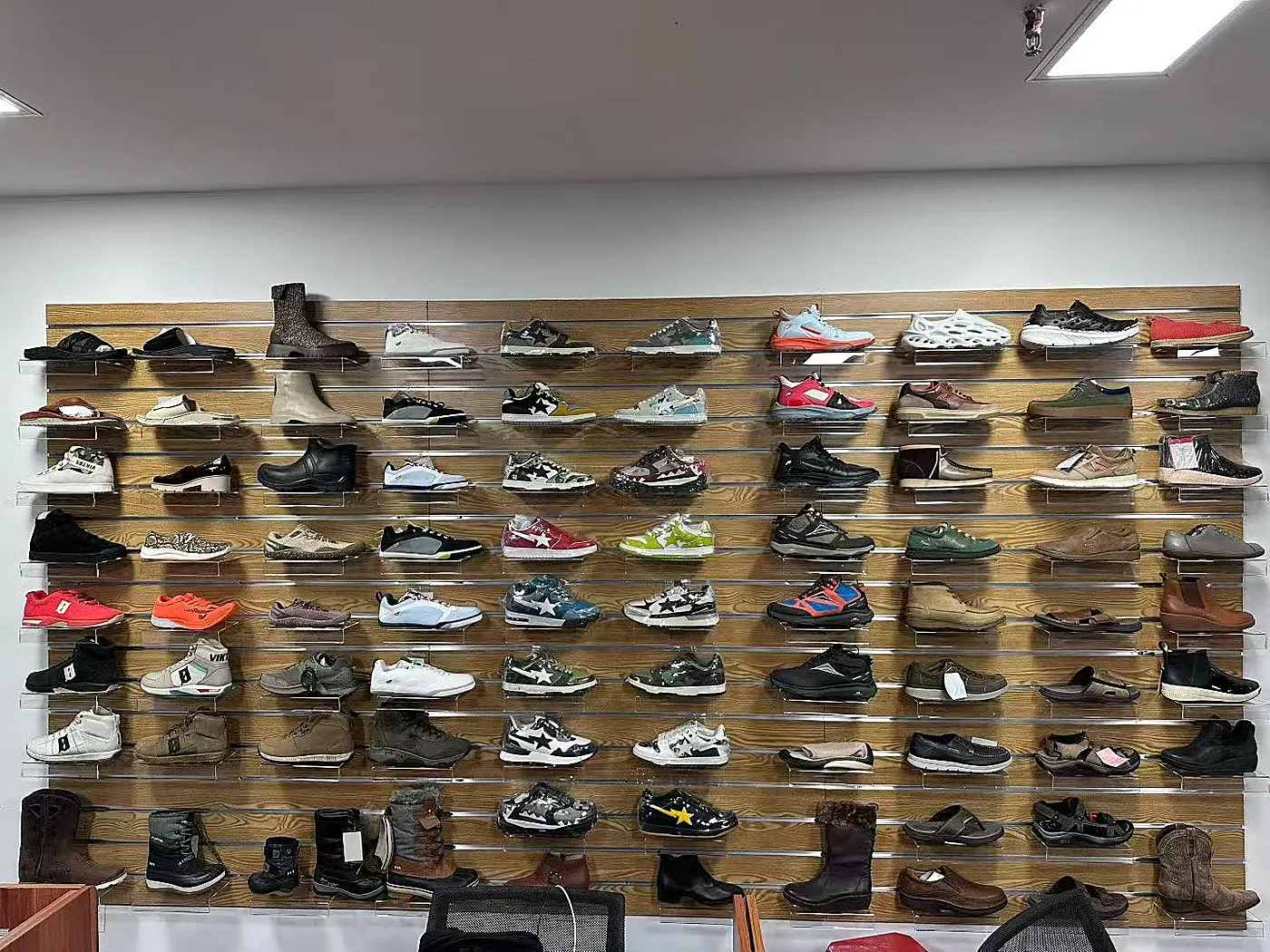 Sample wall at Xinkang with shoe styles developed for customer programs